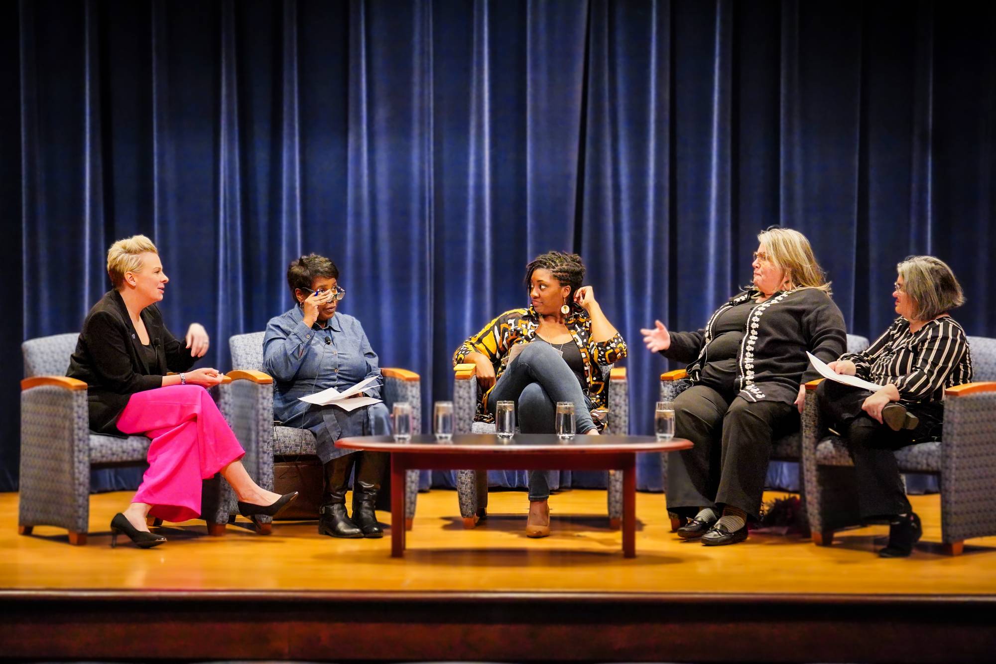 Panelists seated on stage